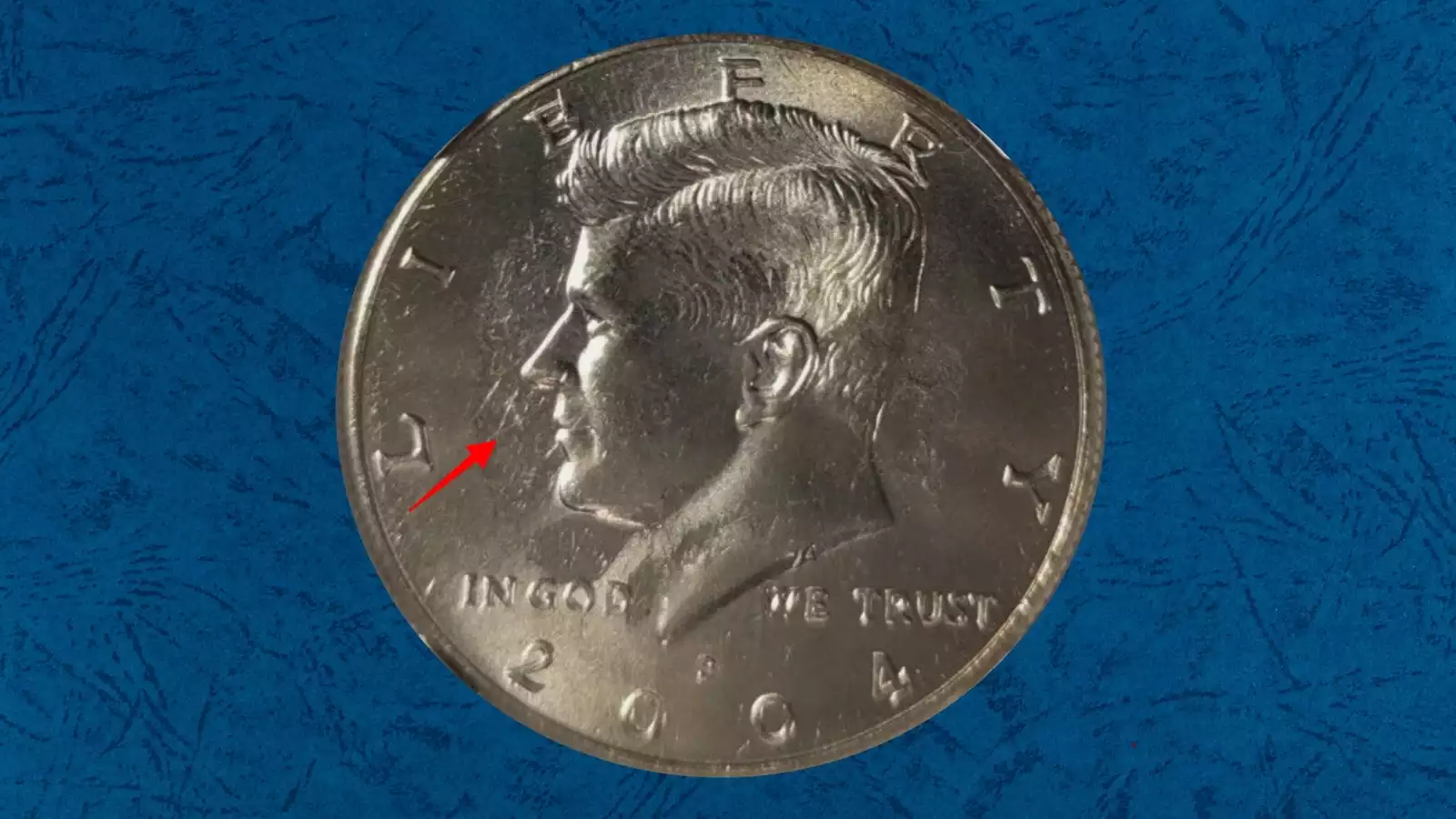 2004 Kennedy half dollar struck-through grease error showing missing design details on the obverse