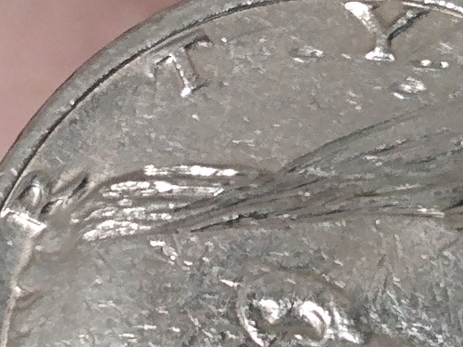2004 Kennedy half dollar die clash error showing ghost impression of eagle design on the obverse portrait field